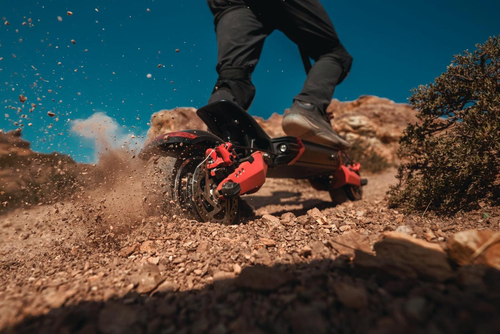 Scooter kicking up dust 